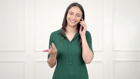 Happy Indian woman talking on a call