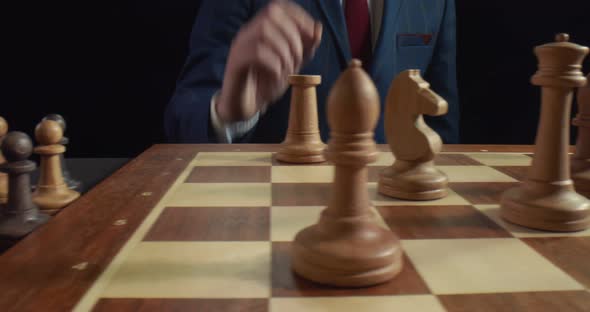 Man Playing Chess Game Moving White Rook Isolated on Black Background