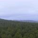 Aerial View Passing Over Tree Covered Mountains Landscape Cloudy Misty Day  - VideoHive Item for Sale
