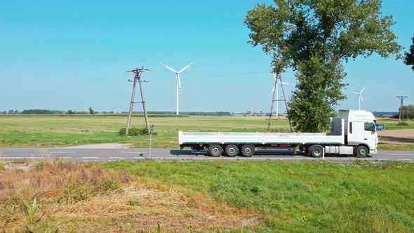 Car Move on Road Near Windmill Farm