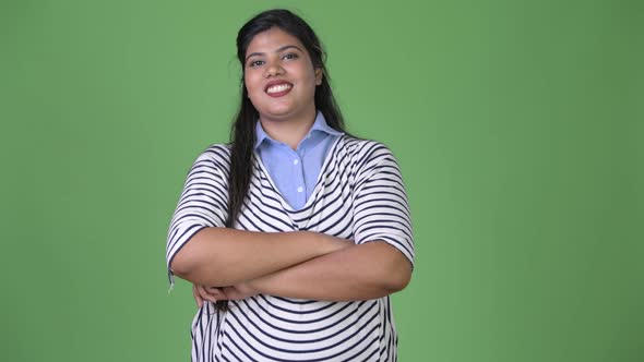 Young Overweight Beautiful Indian Businesswoman Against Green Background