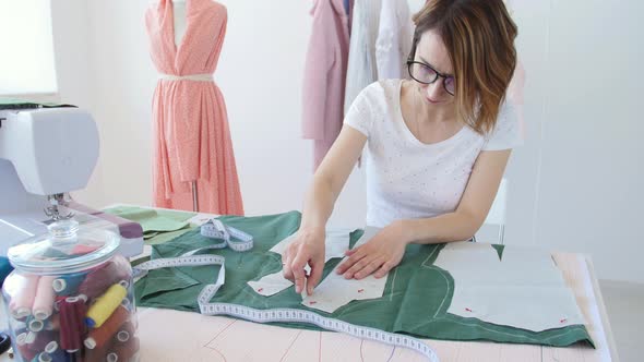 Concept of Hobby and Small Business. Young Female Designer Is Designing Clothes in a Bright Studio