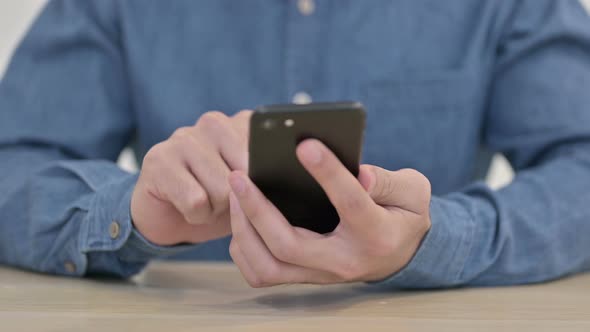 Close Up of Male Hands Using Smartphone 