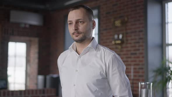 Professional Brunette Waiter with Brown Eyes and Mustache Looking Away Turning to Camera Smiling