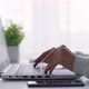 A woman opens a laptop to work at her desk. - VideoHive Item for Sale