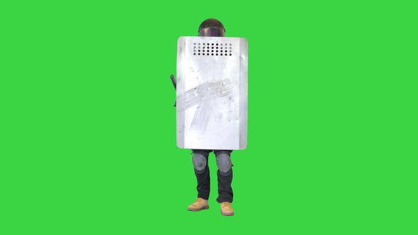 Riot Police Making Noise Hitting His Riot Shield with Baton on a Green Screen Chroma Key