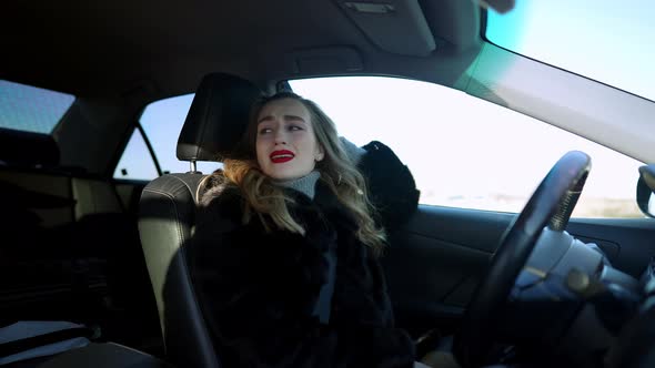 Portrait of Frustrated Beautiful Woman Crying and Sighing Sitting in Car on Driver's Seat