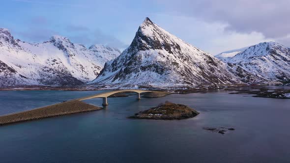 Fredvang Bridge and Volandstind Mountain in Winter. Lofoten, Norway. Aerial View