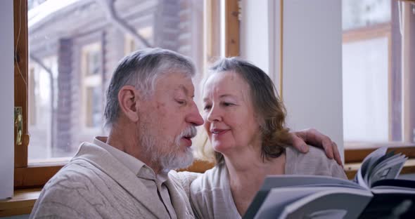 Portrait of an Elderly Couple Leafing Through a Book