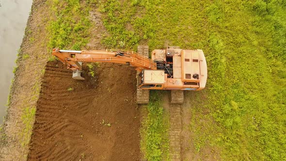 Excavator Digging a Trench in the field.Aerial Video.