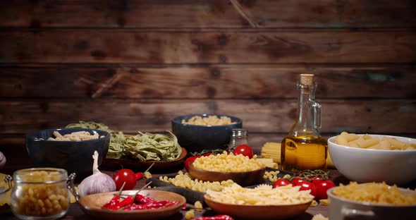 Different Types of Dry Pasta in Plates Slowly Rotating. 