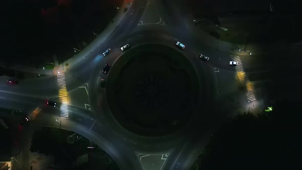 Aerial View Timelapse of Roundabout Road with Circular Cars at Night in Small European City