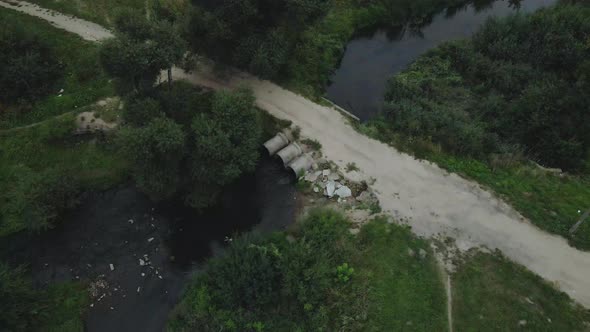 Flying over concrete sewers. Streams of water flow through concrete pipes