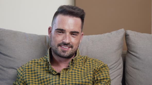 Portrait of a Young Man Looking at Camera Smiling at Home