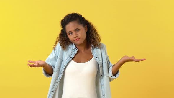 Young unhappy African American woman acting unsure and displeased