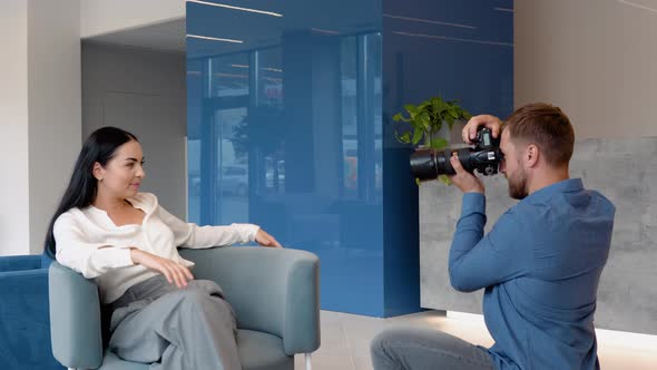 Photographer is Photographing a Model Posing in Business Centre