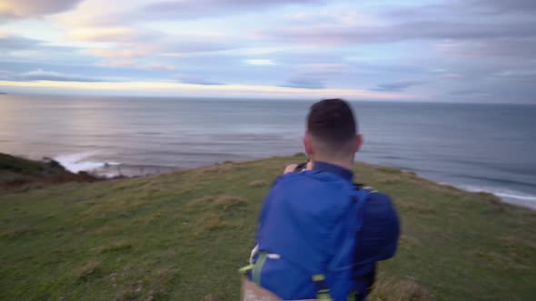 Slow motion shot of bridal couple running to viewpoint