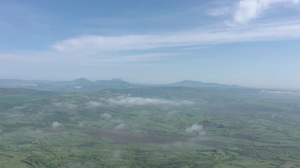 Foggy morning and clouds above valley of Stol Deli Jovan and Veliki KRs mountains 4K aerial video