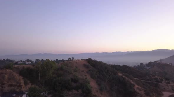 AERIAL: Over Hollywood Hills at Sunrise with View on Hills and the Valley in Los Angeles View 