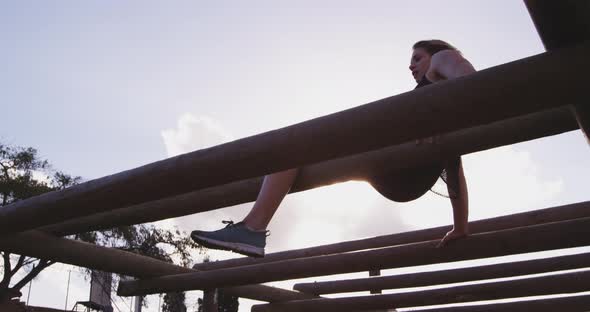 Young woman training at an outdoor gym bootcamp