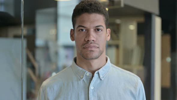 Serious Young African Man Looking at Camera