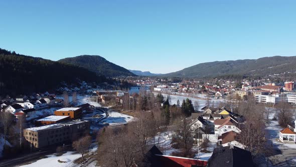 Numedalslagen river in Kongsberg city Norway - Slow sunny winter day aerial from Hasbergtjerndalen l