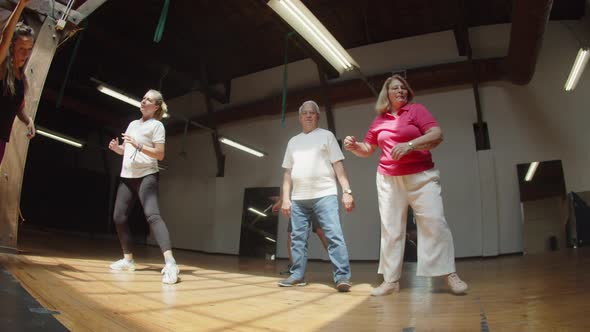 Long Shot of Excited Senior People Learning Dance Combination