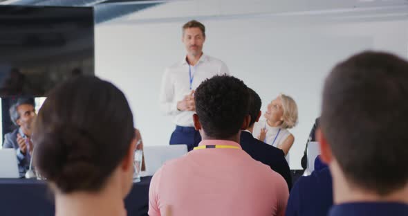 Speaker addressing the audience at a business conference