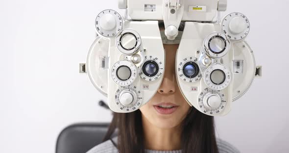 Woman checking on eye in clinic