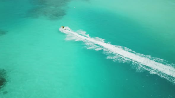 Aerial View of Jet Ski Racing on a Crystal Clear Turquoise Water in Maldives