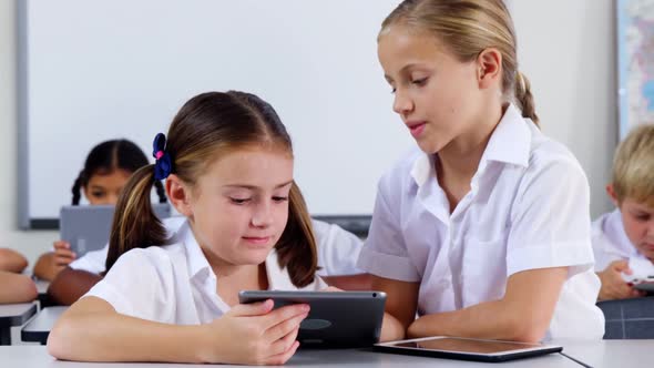 School kids using digital tablet in classroom