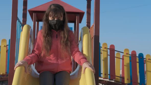 Childhood in a mask on the playground. 
