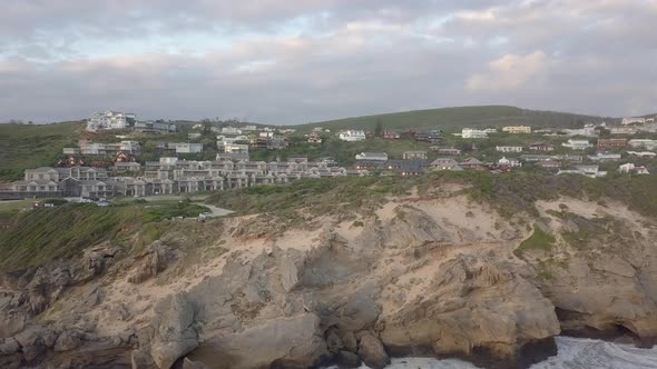 Steep rugged shoreline at Brenton on Sea with seagull attack, aerial