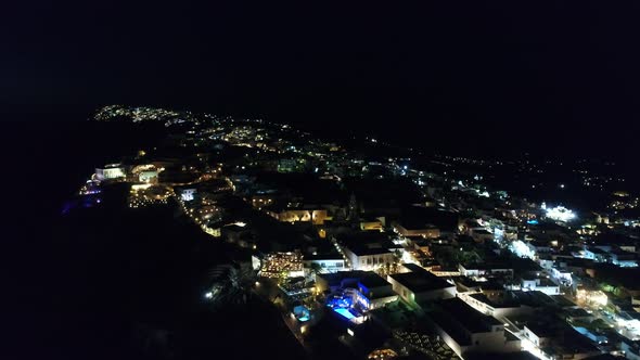 City of Santorini by night on the island of Santorini in Greece from the sky