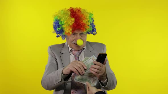 Senior Clown Businessman Entrepreneur Loses Money While Working on Phone Online