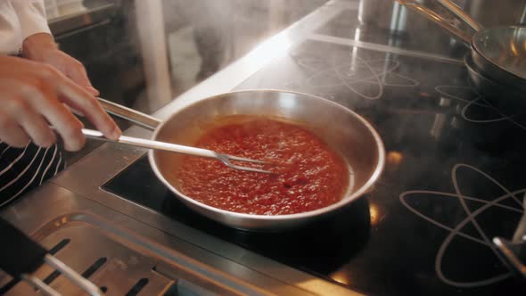 Chef Cooking Tasty Pasta Tomato Sause on Restaurant Kitchen Traditional Italian Food High Kitchen
