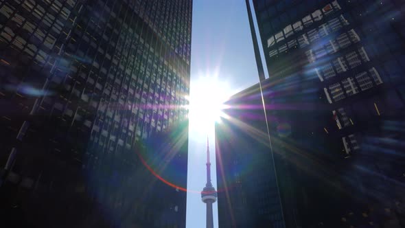 Tower With Two Tall Downtown Office Buildings On Sunny Day With Canadian Flag