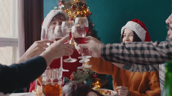 Family in Christmas Hats Clink Glasses with Wine and Champagne Father of Family Drinks Wine