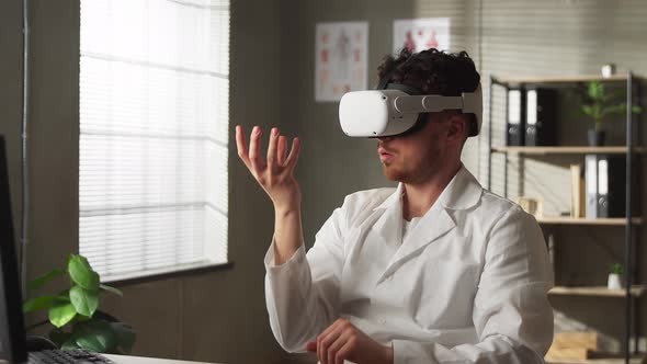 Male Doctor Conducting Experimental Medical Procedure Wearing Virtual Reality Headset