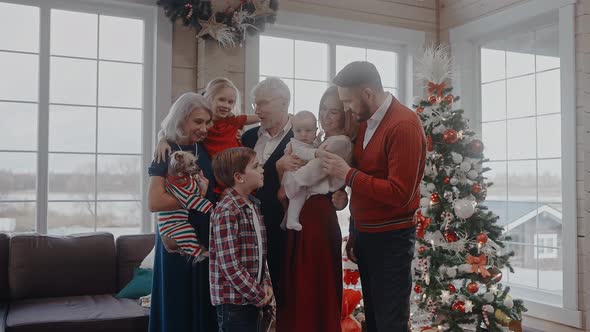 Family with Kids and Grandparents Dressed Up for Christmas Eve Look at Camera