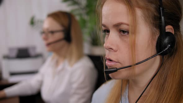 Smiling Female Customer Support Operator with Headset Working in Office