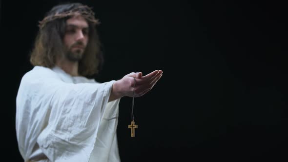 Male Hand Taking Wooden Cross Necklace From Jesus, Salvation of Soul, Faith