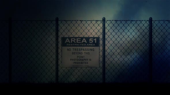Zoom In Into An Area 51 Sign On A Metal Fence On A Stormy Night