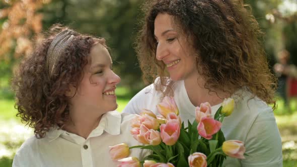 Portrait of a Mother and Daughter of a Teenager Looking at Each Other with Love and Tenderness