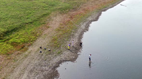 Four Teenagers Spend Time on the River Bank