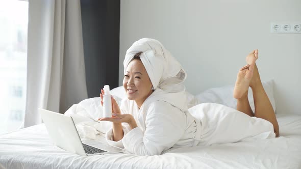 An Attractive Chinese Woman Uses a Laptop To Conduct Online Correspondence with Her Friends and