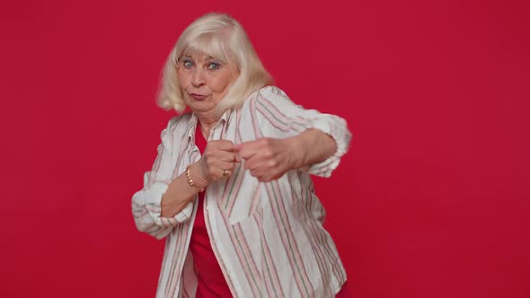 Senior Old Woman Making Fight Threat at Camera Shaking Fist Punch Boxing with Expression Punishment