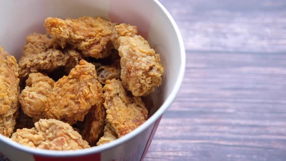 Crispy Fried Chicken Wings in a Takeaway Bucket on Table