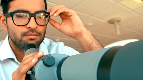 Executive looking through telescope