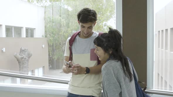 Teenage friends talking and using phone